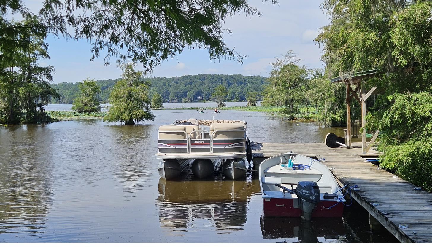 Boats tied up at the Cypress Landing dock on Gantt Lake