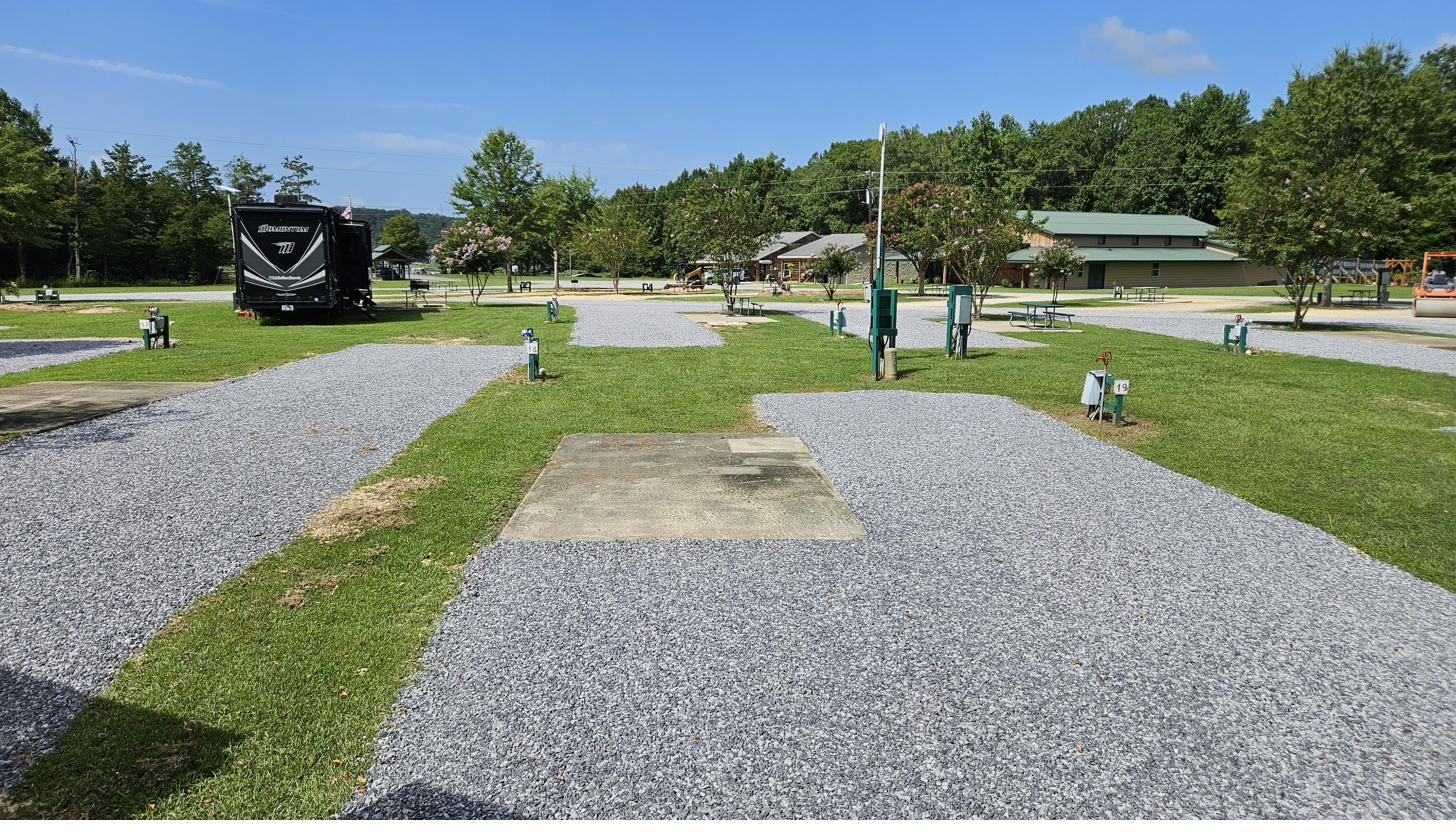 A wide, level gravel RV site ready for arrival at Cypress Landing